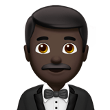 Man in Tuxedo Emoji with Dark Skin Tone, Apple style